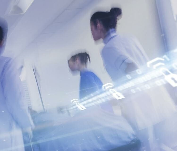 Healthcare workers moving through a hospital corridor with digital overlays of padlocks and binary code, symbolizing secure data transmission in wireless medical devices.