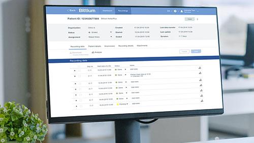 Computer monitor displaying patient data on Bittium software interface in a medical office.