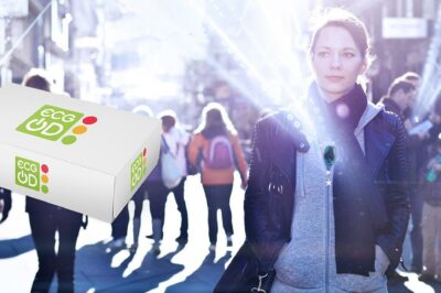 Woman walking in a city wearing a wireless ECG device, with a floating ECG On-Demand package in the foreground.