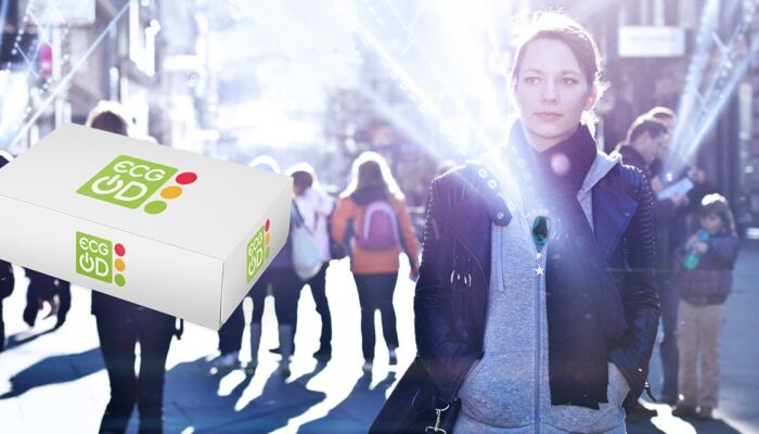 Woman walking in a city wearing a wireless ECG device, with a floating ECG On-Demand package in the foreground.